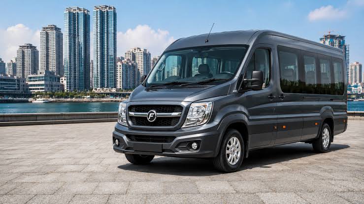Force Urbania medium wheelbase minibus parked on a city waterfront road