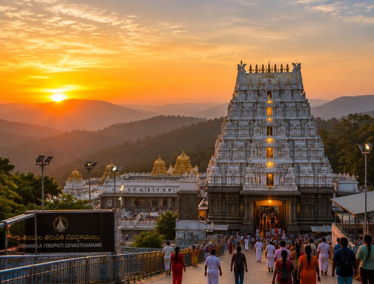 Tirumala Tirupati temple at sunrise with devotees walking towards the gopuram